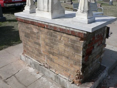 Deteriorated brick façade restoration — before