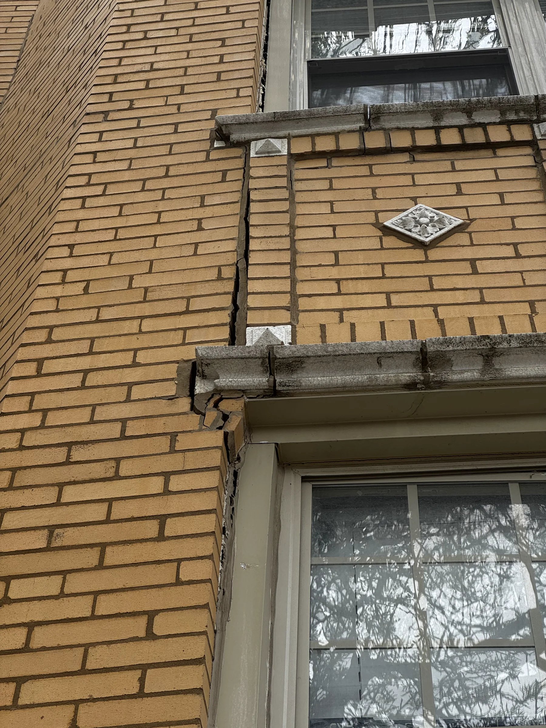 Stair-step cracking around a window opening on a Chicago brick building