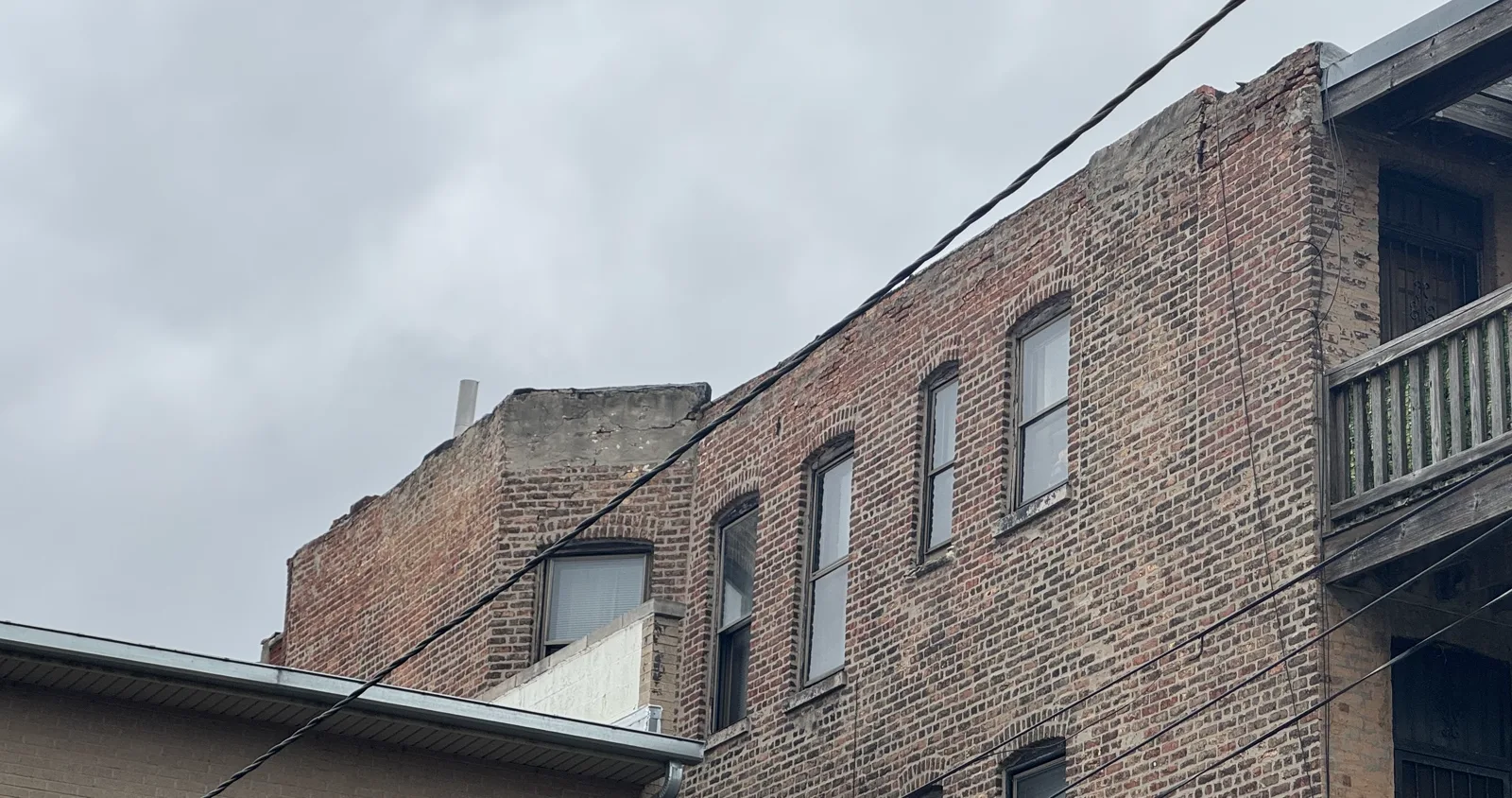 Brick facade with failing parapet wall mortar joints