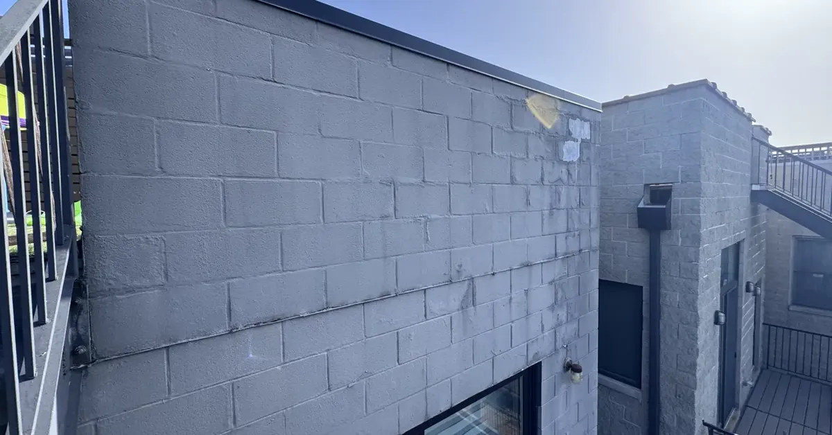 Cinder block wall with visible water staining and efflorescence